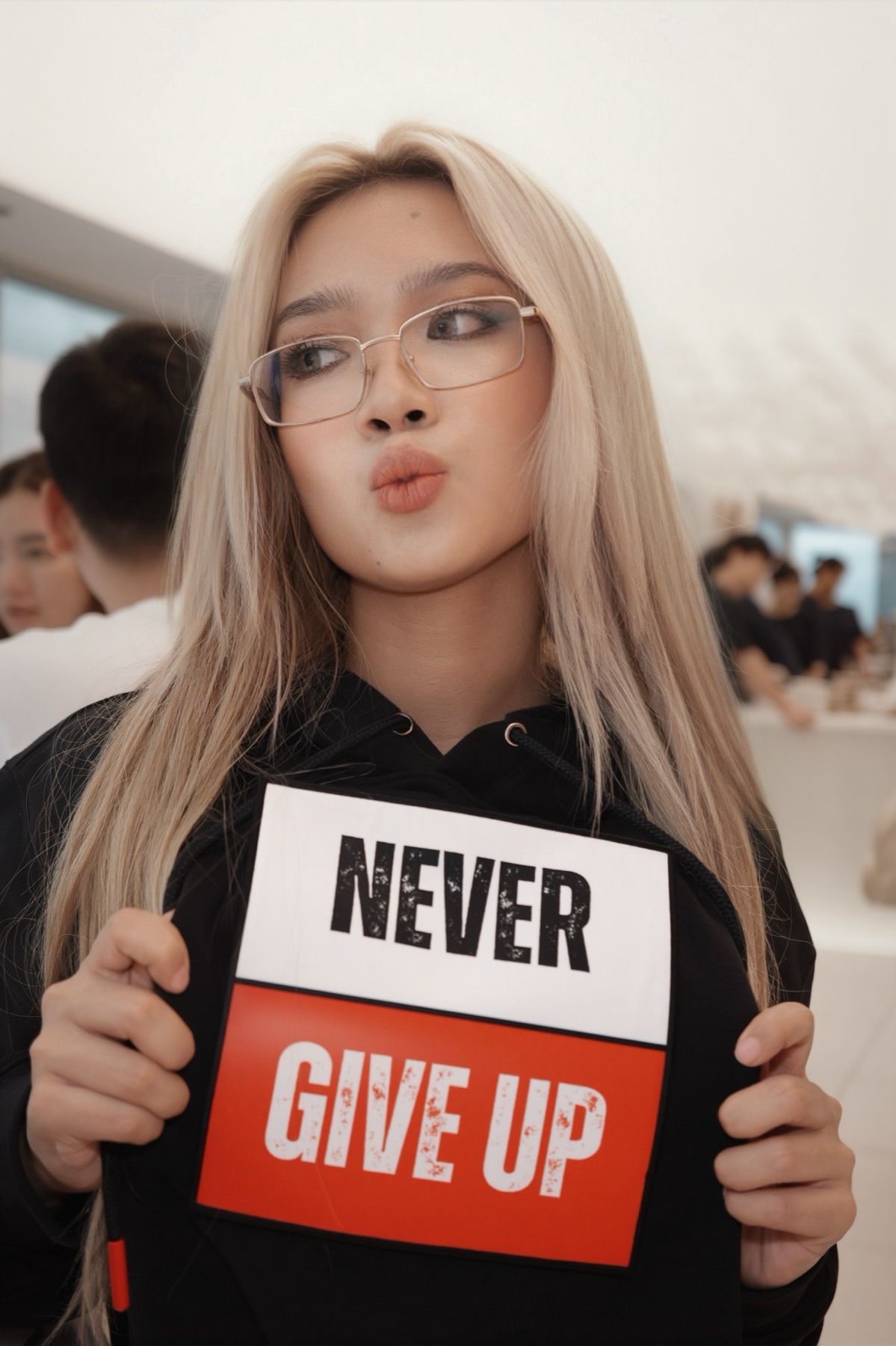Close-up of the model in the Never Give Up hoodie